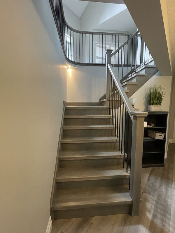 Curved staircase with wood treads and slim metal spindles